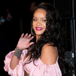 Rihanna wearing a pink top. 