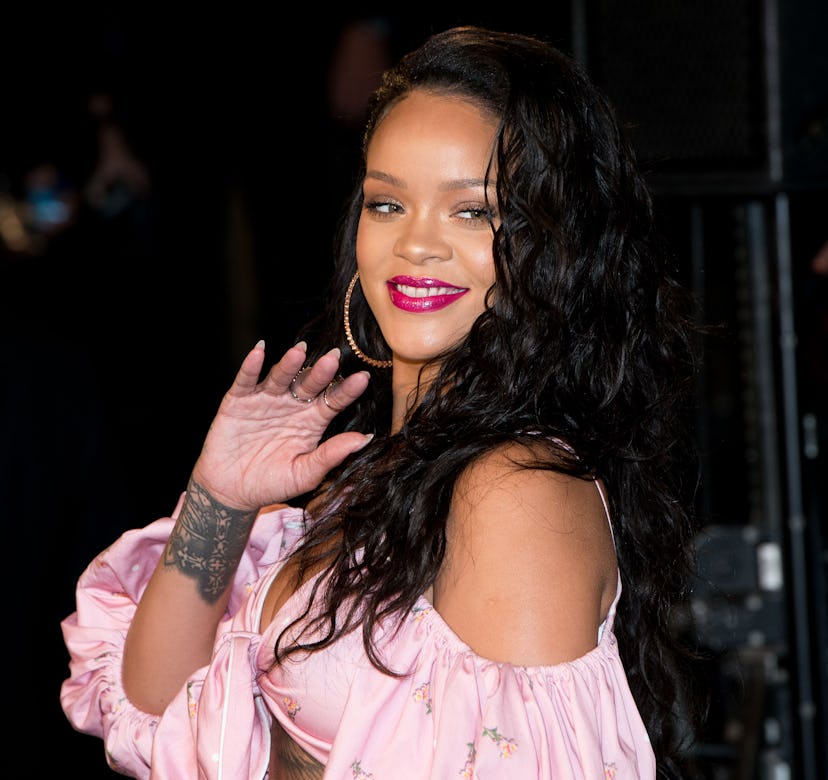 Rihanna wearing a pink top.