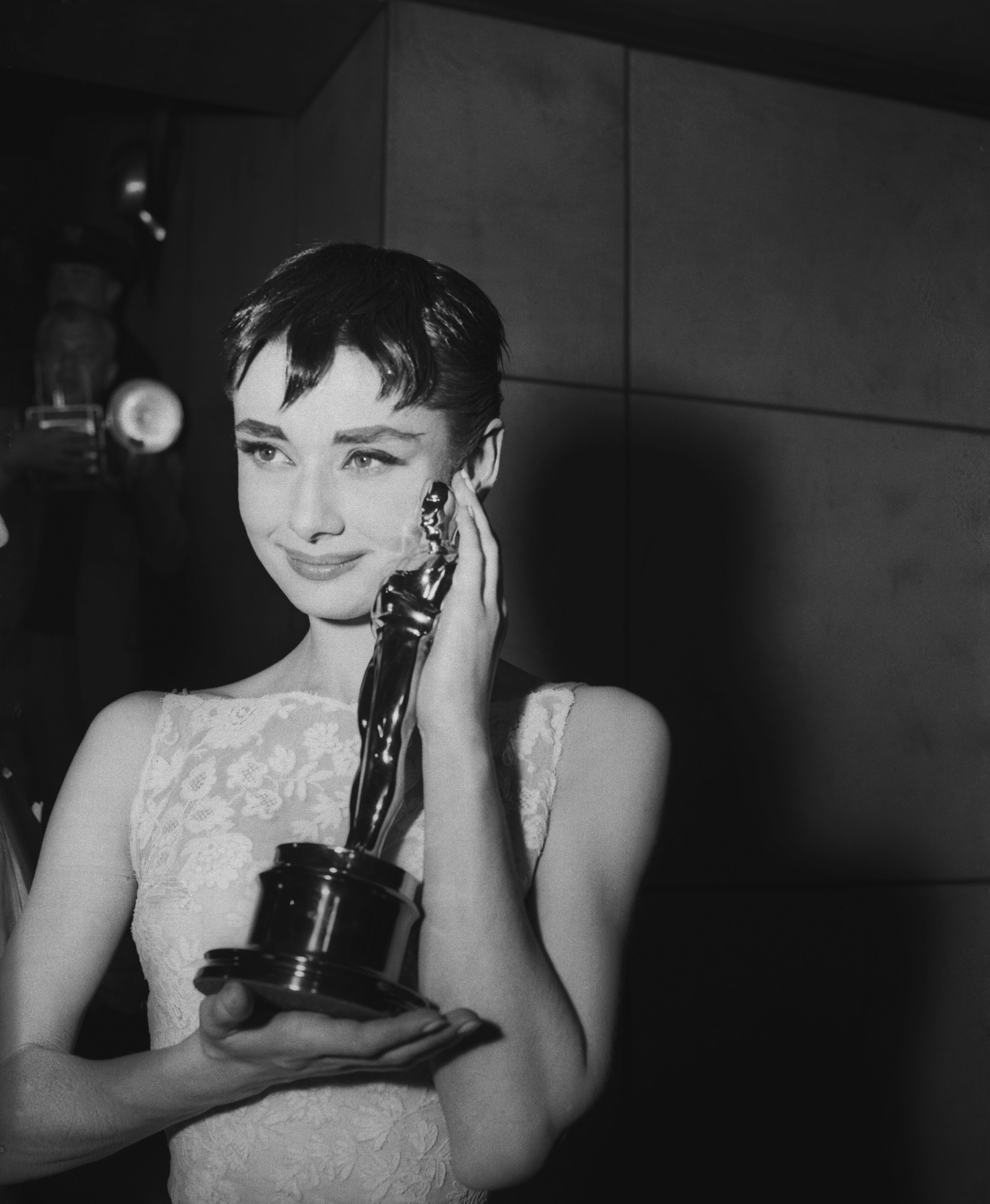 Audrey Hepburn holding the Academy Award for best actress in Roman Holiday, her first American film.