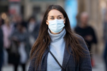 CARDIFF, WALES - MARCH 25: A woman wears a face mask on Queen Street on March 25, 2022 in Cardiff, W...