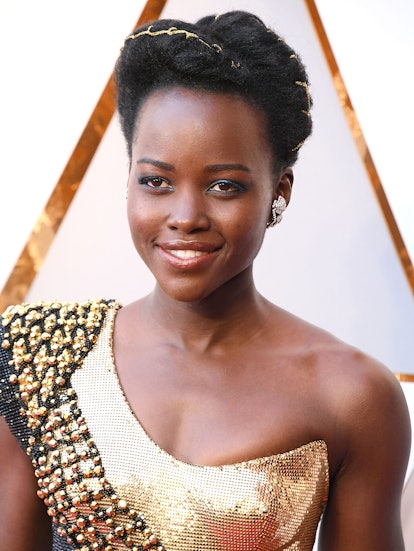 Lupita Nyong'o's updo with golden accents at the Oscars.