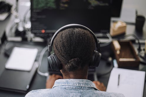 woman working while wearing headphones