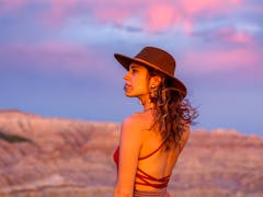 Young woman in the desert during sunset, embracing the spiritual meaning of the April 2022 new moon ...