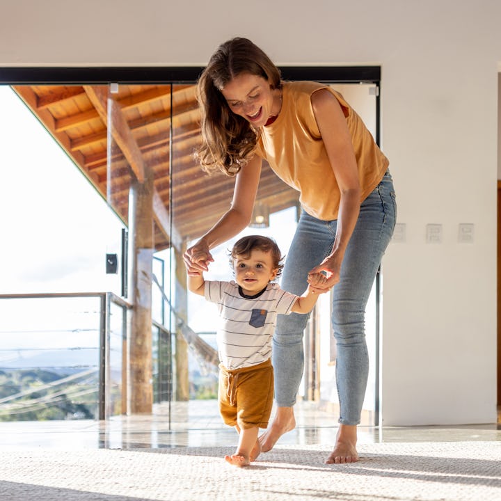 A Brazilian baby boy learns to walk with the help of his mother.