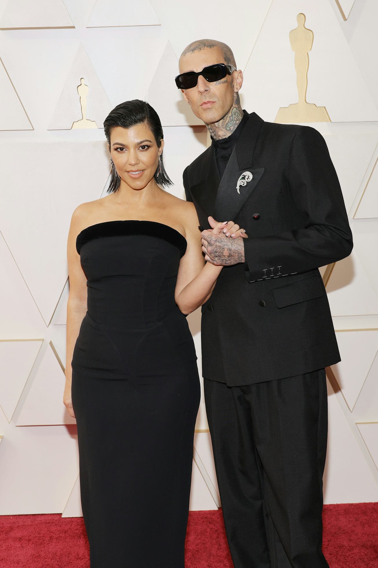 HOLLYWOOD, CALIFORNIA - MARCH 27: (L-R) Kourtney Kardashian and Travis Barker attend the 94th Annual...
