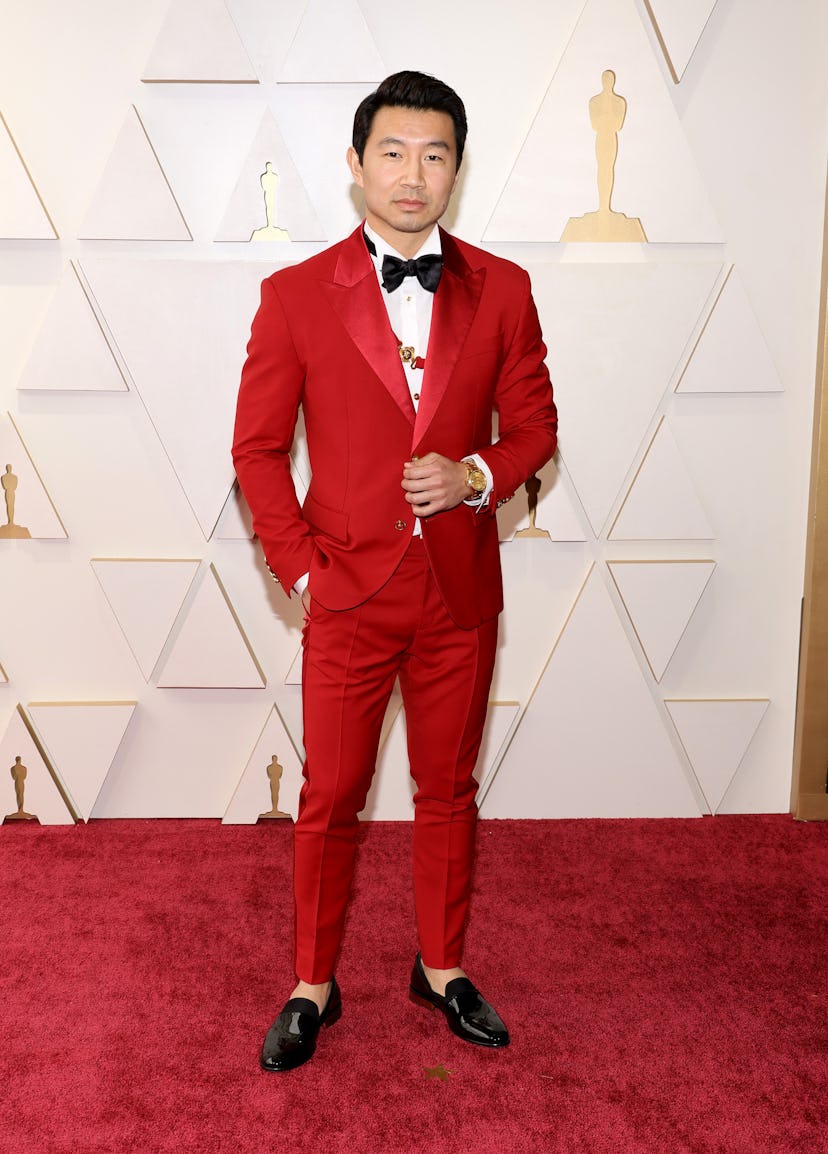 The 2022 Oscars red carpet was full of celebrities in red outfits. Here, Simu Liu. 