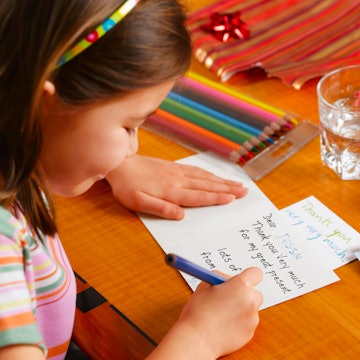 A young kid writing thank you notes