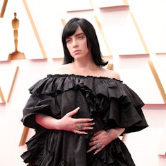 Billie Eilish wears a full-length tiered Gucci gown on the 2022 Oscars red carpet. 
