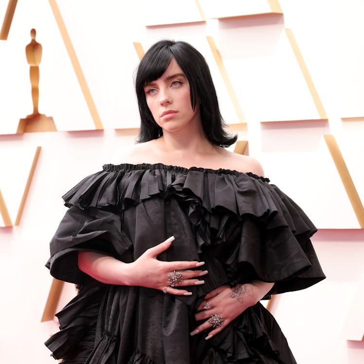 Billie Eilish wears a full-length tiered Gucci gown on the 2022 Oscars red carpet. 