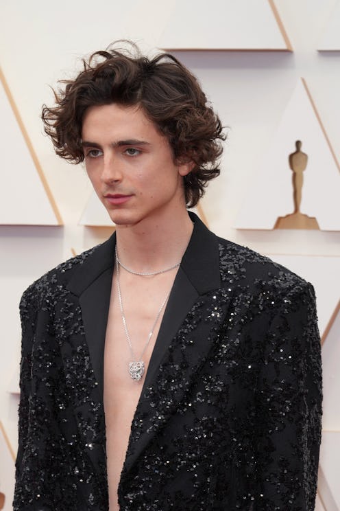Timothée Chalamet at the 2022 oscars wearing a black blazer with no shirt underneath