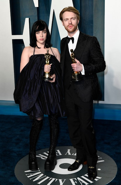 US singer-songwriter Billie Eilish (L) and US singer-songwriter Finneas O'Connell hold the award for...