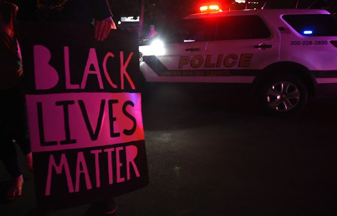 CORRECTED CAPTION WASHINGTON, DC - JULY 7: A protestor holds a Black Lives Matter sign outside of th...