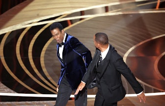 HOLLYWOOD, CA - March 27, 2022.    Will Smith slaps Chris Rock onstage during the show  at the 94th ...