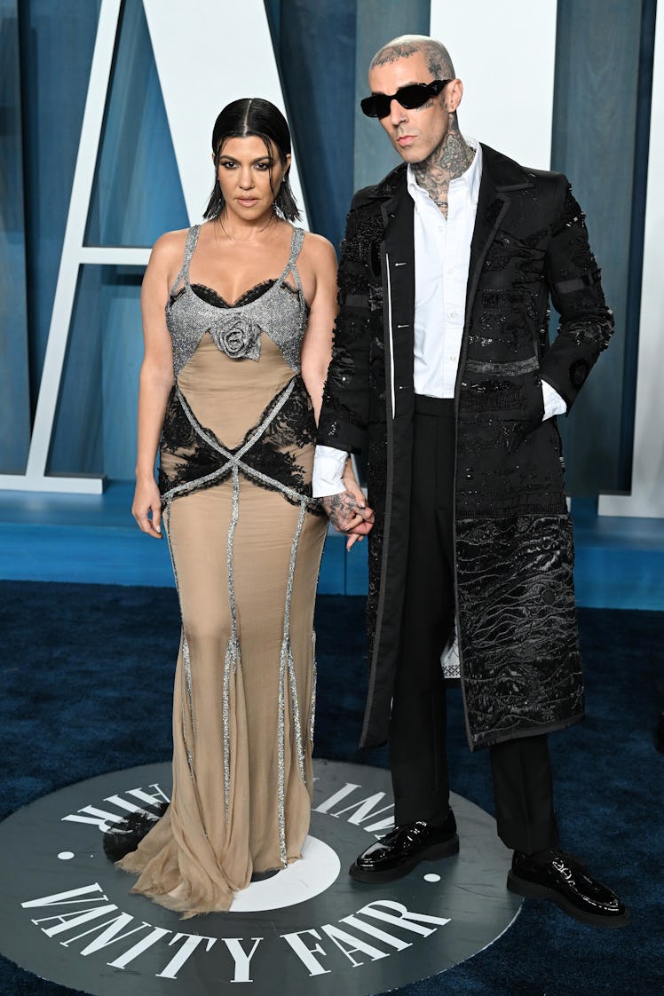 Kourtney Kardashian and Travis Barker attend the 2022 Vanity Fair Oscar Party 