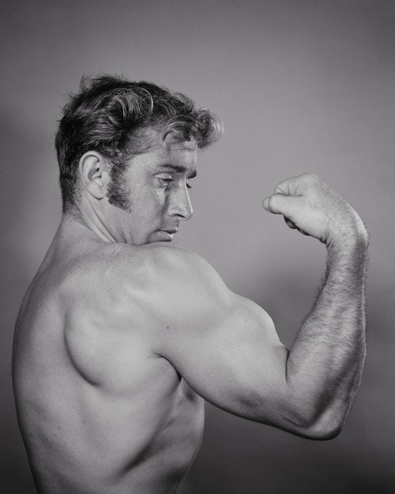 1970s MALE BODY-BUILDER PROUDLY SHOWING OFF LARGE MUSCULAR BICEPS  (Photo by H. Armstrong Roberts/Cl...
