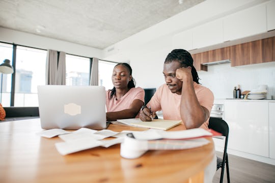 A couple is checking out they bills and making payments online.