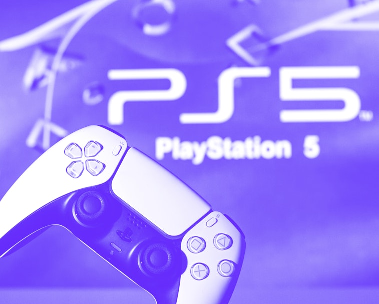 SPAIN - 2021/11/08: In this photo illustration, a PlayStation 5 controller seen with a PlayStation 5...