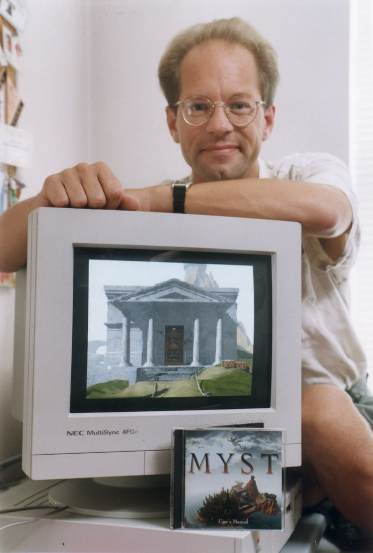 James Lileks posing with the "MYST" game CD cover and the game on a computer