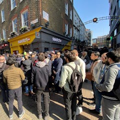 Customers congregate at the doors to the closed Swatch store on Carnaby Street, central London, afte...