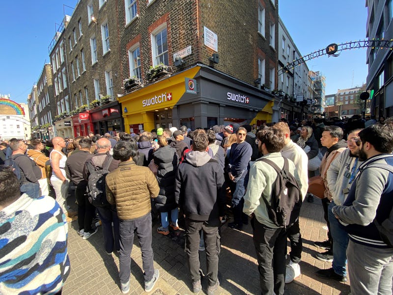 Customers congregate at the doors to the closed Swatch store on Carnaby Street, central London, afte...