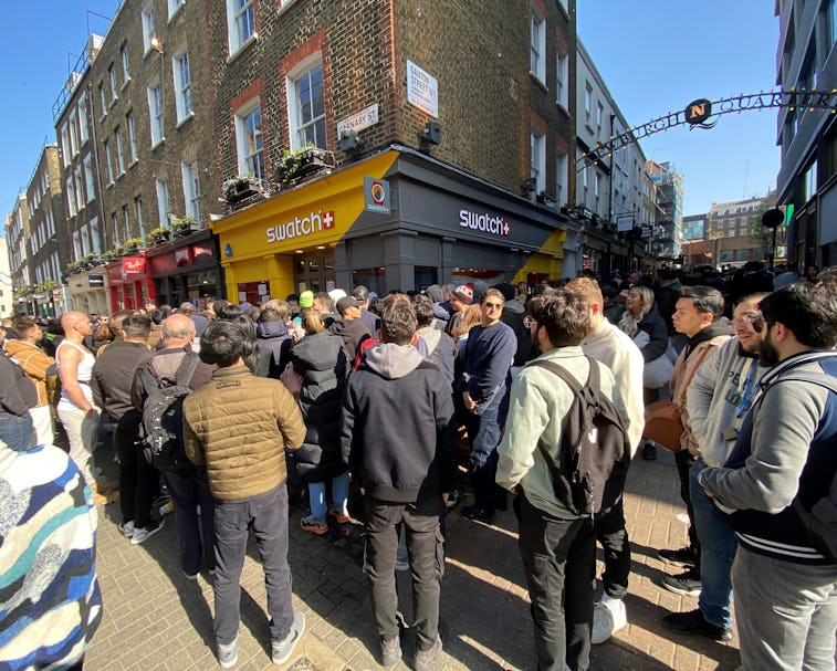 Customers congregate at the doors to the closed Swatch store on Carnaby Street, central London, afte...