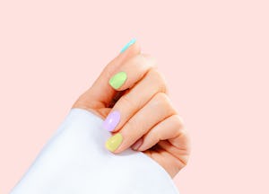 Hand with pastel color manicure on Easter.