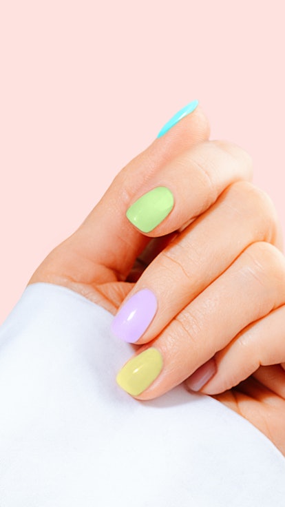 Hand with pastel color manicure on Easter.