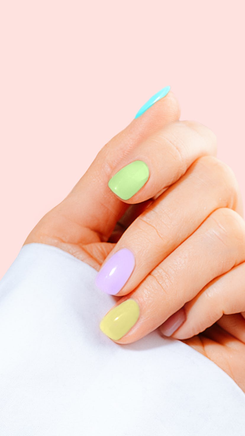 Hand with pastel color manicure on Easter.