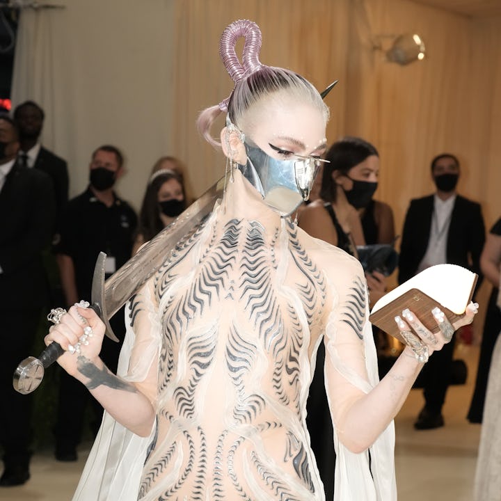 Grimes at the Met Gala reading a book - not to be confused with the 'intergalactic children's metave...
