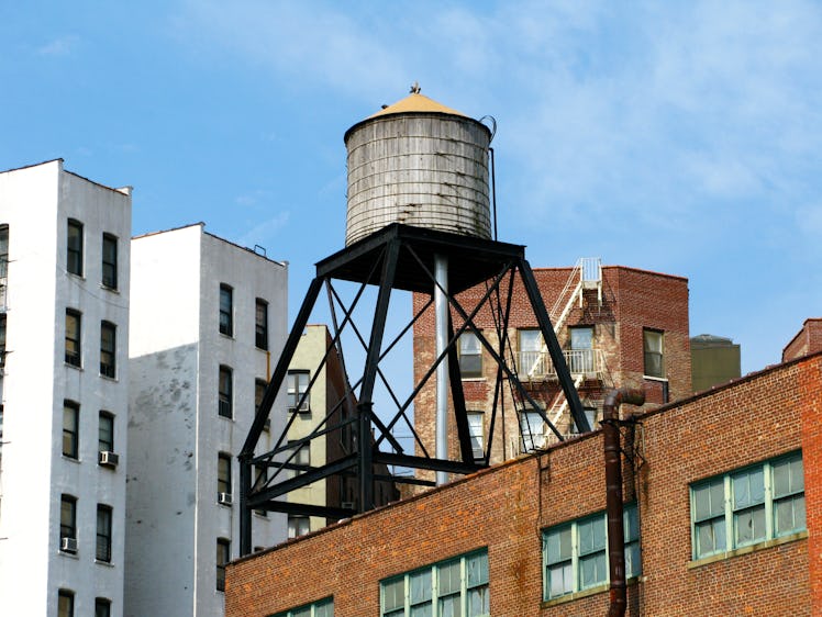 An old wooden water tank and its metal structure on the roof of a building in Manhattan, New York, U...