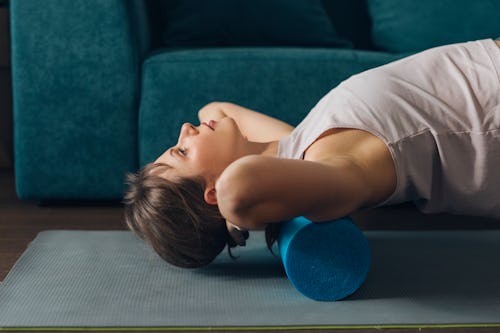 A woman uses a foam roller. Here's your daily horoscope for March 30, 2022.
