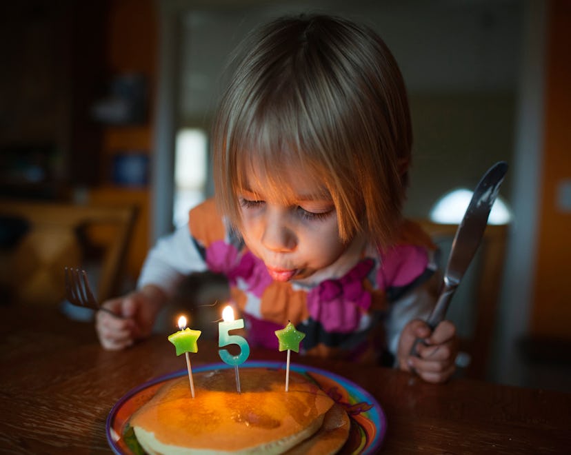 instagram caption suggestions for this photo of girl blowing out 5th birthday candle 