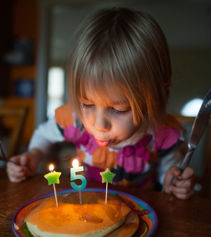 instagram caption suggestions for this photo of girl blowing out 5th birthday candle 