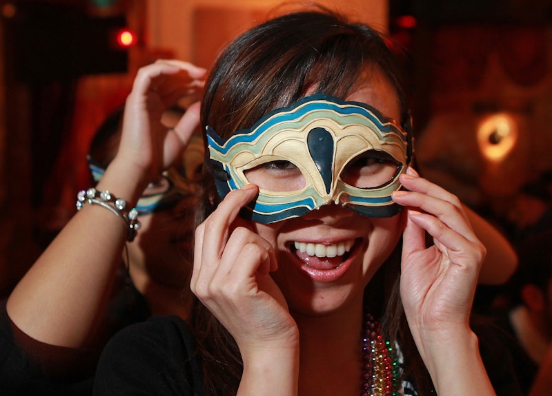 Boston, MA — Hazel Pham, 23, of South Boston, helps Emma Nguyen, 23, of Braintree put on her mask at...