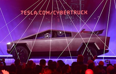 People take pictures of the newly unveiled all-electric battery-powered Tesla's Cybertruck with shat...