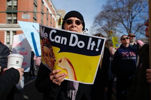 A man holds a poster as he attends the Womens March on New York City on January 20, 2018 in New York...