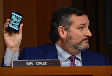 Senator Ted Cruz (R-TX) holds up a cellphone during the confirmation for Supreme Court nominee Judge...