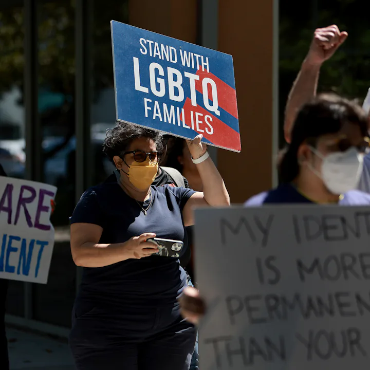 People protesting against the 'Don't Say Gay' bill, which LGBTQ+ groups are now suing the state of F...