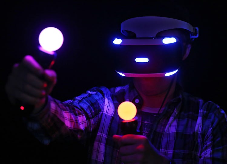 A visitor tests a pair of new 'Project Morpheus' 3D virtual reality glasses by Sony at the computer ...