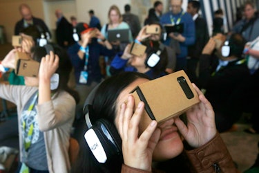 Google I/O 2015 attendees use Google Cardboard to try out the Expeditions app during Google I/O 2015...
