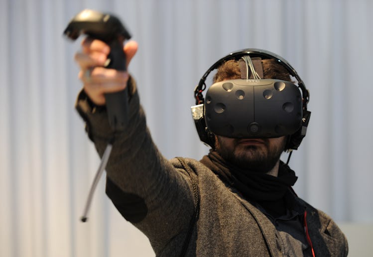 A visitor tests the Vive virtual reality glasses by HTC at the Mobile World Congress in Barcelona, S...