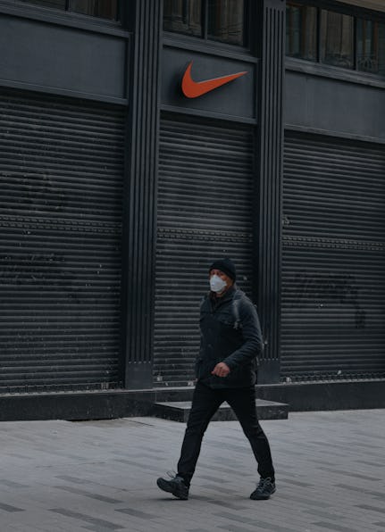 22 April 2020, Istanbul, Turkey - Closed shutters of famous Nike clothing shops on empty Taksim Isti...