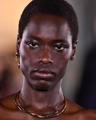 A model wearing Cartier jewelry at Sacai's Fall/Winter 2022 runway show. 