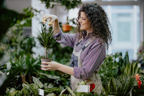 A woman tends to plants. Here's your daily horoscope for March 7, 2022.