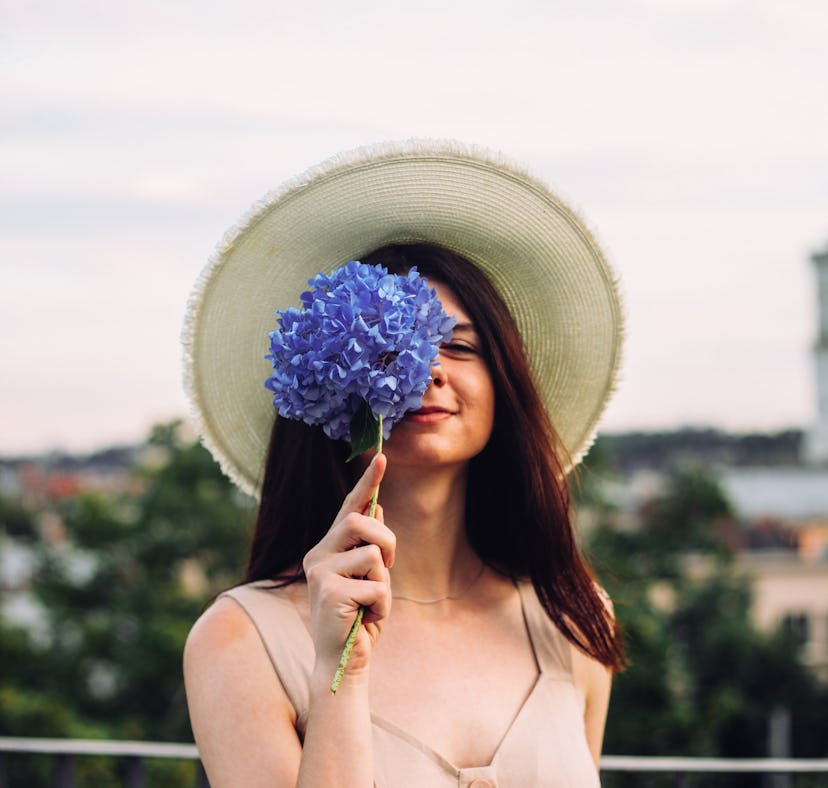 Woman holding a Very Peri bouquet for spring 2022.
