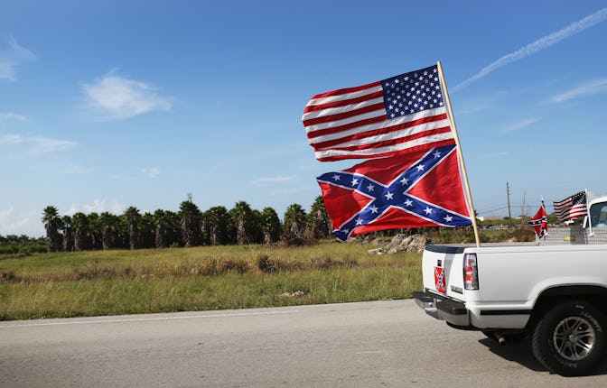 LOXAHATCHEE, FL - JULY 11: An American and Confederate flag fly from a vehicle during a rally to sh...