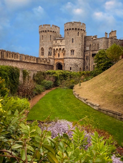 view along a lawn and gardens of the St George's Gate at  Windsor Castle, at Windsor England, in the...