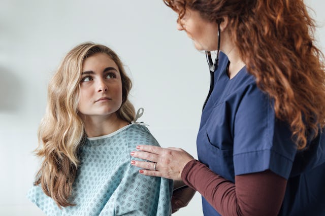 A teen girl speaks with a physician -- teen visits to the ER have spiked during COVID-19. 
