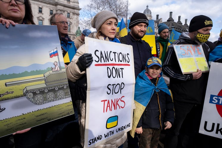 Sanctions don't stop tanks placard as Ukrainian community gather in Parliament Square to protest aga...