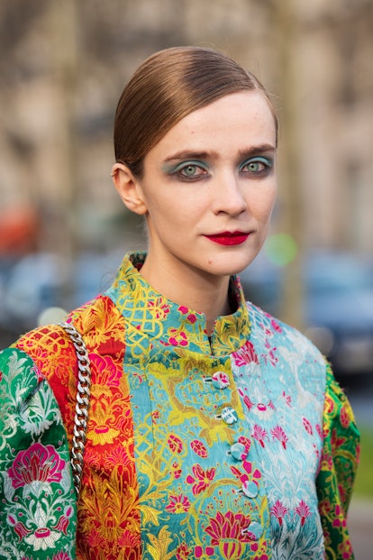 Model Lynn Palm wears vibrant makeup on February 26, 2020 in Paris, France.